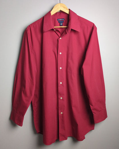 Folded red shirt on a gray background