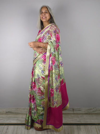 Woman wearing a floral dress pink saree on a gray background