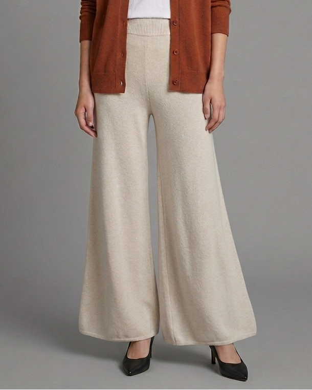 Woman wearing beige wide-leg pants on a gray background
