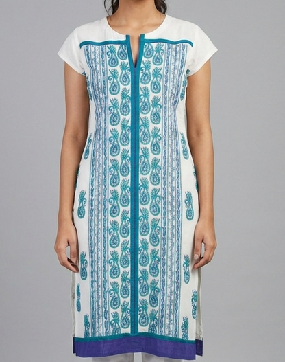 Woman wearing a white and blue patterned kurta with white pants on a gray background