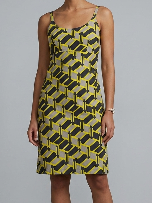 Woman wearing a yellow and black patterned dress against a gray background