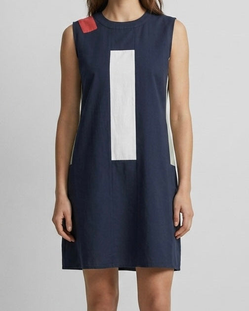Navy dress with a large white block on a plain background