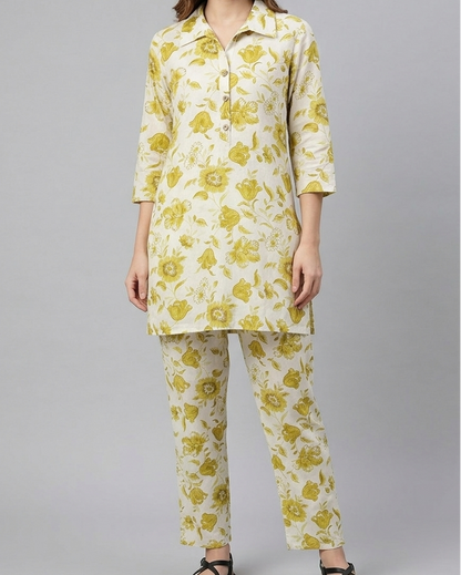 Woman wearing a yellow floral outfit on a gray background