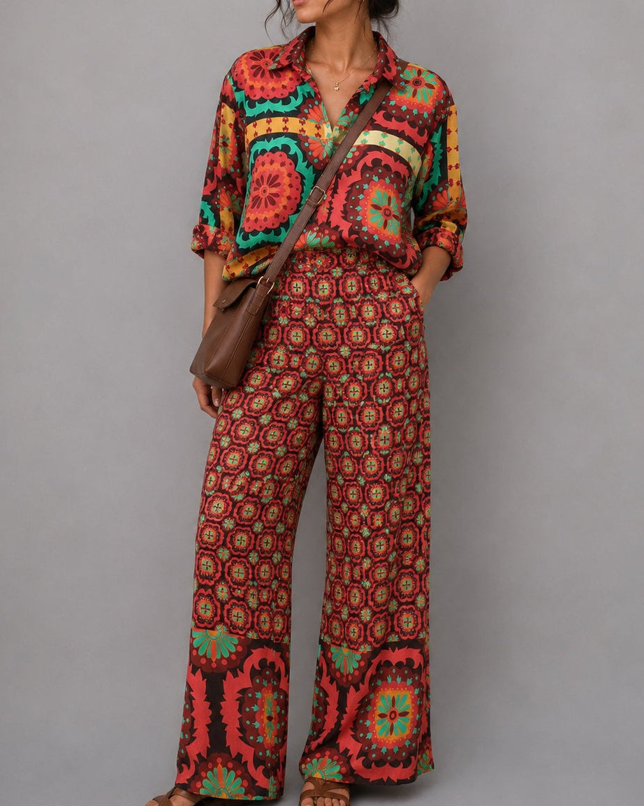Woman wearing a colorful patterned outfit with a gray background