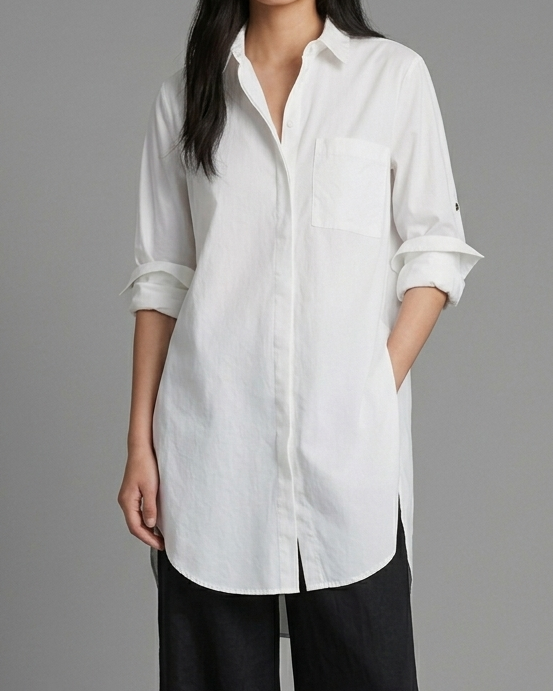 Woman wearing a white shirt and black pants on a gray background