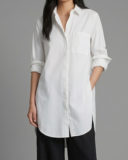 Woman wearing a white shirt and black pants on a gray background